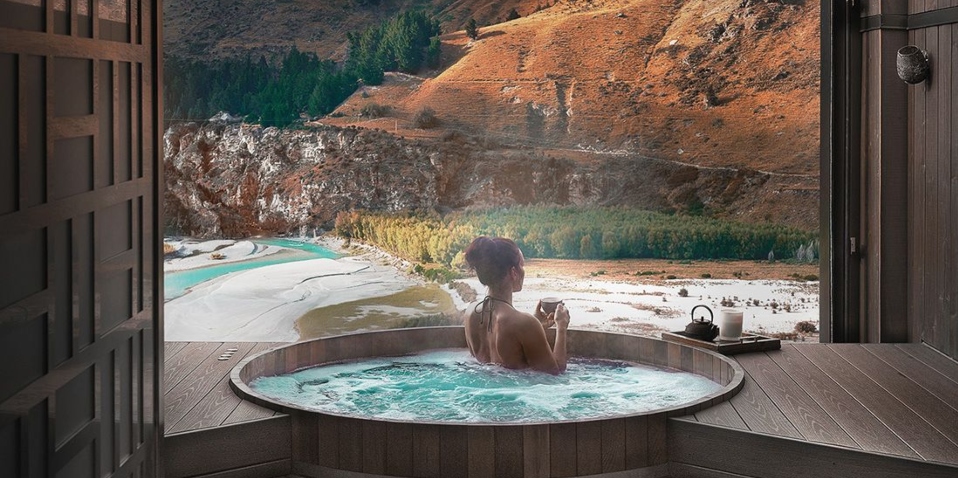 Relaxing in luxury cedar-lined Onsen Hot Pools looking out over views of Queenstown's Shotover River