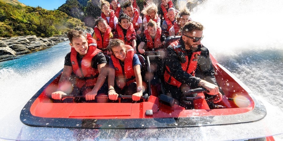 Close up shot of happy customers on the Shotover Jet being sprayed by water droplets